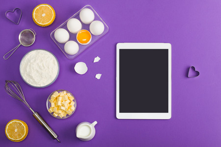Kitchen baking mobile tablet application service website mockup with eggshells, butter, milk,...