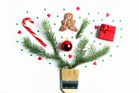 Draw me Christmas creative concept. Christmas new year winter holiday composition wooden brush fir tree branches ball gift box ginger man cookie candy cane hearts spruce. Flat lay top view copy space.の写真素材