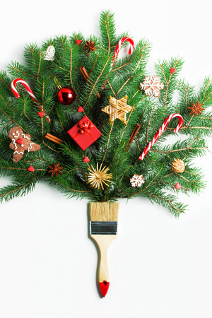 Draw me Christmas creative concept. Christmas new year winter holiday composition wooden brush fir tree branches decorated with marshmallows candies gift box Christmas toys. Flat lay, top view.の写真素材