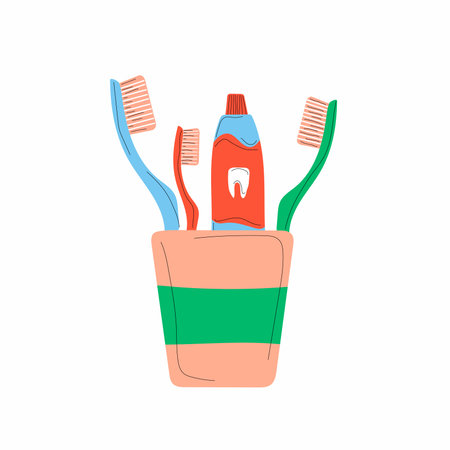 Icon with adult and child toothbrushes, toothpaste in a glass with shade, isolated in a flat illustration.のイラスト素材