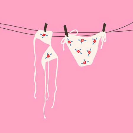 A white swimsuit with a delicate floral pattern hanging on a clothesline under the sunのイラスト素材