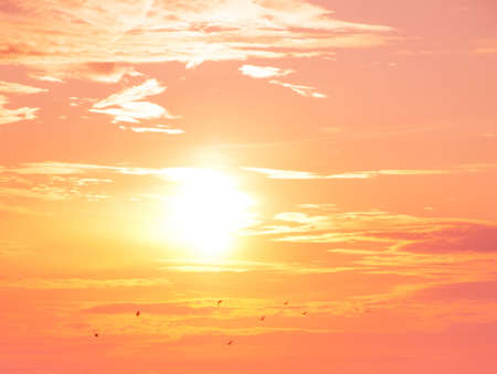 Sunset. Beautiful landscape with clouds and orange sun in the skyの写真素材