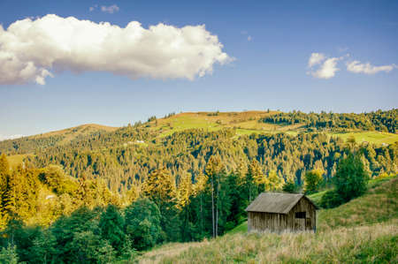 beautiful landscape of autumn mountains with a small hill on them
