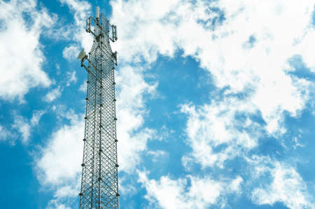 tower with antens for mobile communication and Internet transmission against the blue skyの写真素材