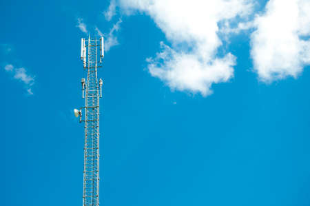 tower with antens for mobile communication and Internet transmission against the blue skyの写真素材