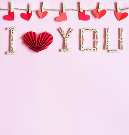 inscription declaration of love under red hearts made of paperの写真素材