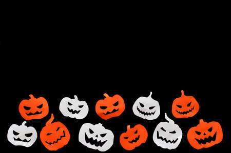 neloween, paper pumpkins orange and white on a black background, isolatedの写真素材
