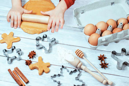 gingerbread, childrens hands rolling out dough, preparing for Christmas