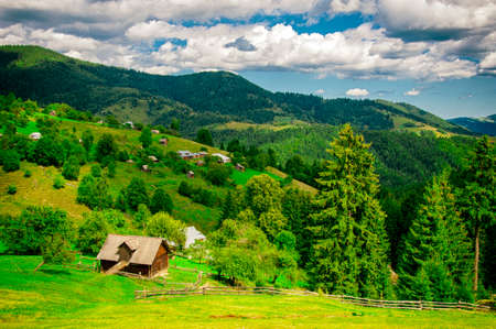 wooden house on the slopes of the mountains, beautiful summer landscape, travel, selective focusの写真素材