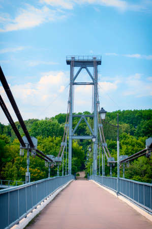 pedestrian bridge over the river in the parkの写真素材