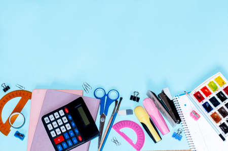 top view of school subjects on a blue background with space for text, school conceptの写真素材