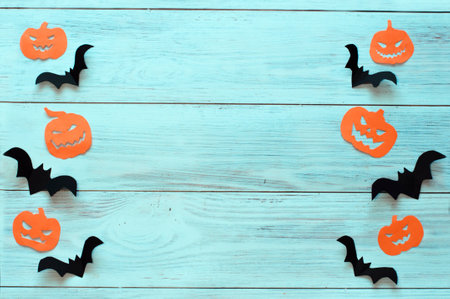 holiday of hinoween, paper pumpkins and bats on a light wooden backgroundの写真素材
