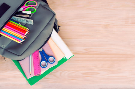 school backpack with other school supplies with space for textの写真素材