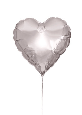 a gray heart-shaped flying balloon on a white isolated backgroundの写真素材
