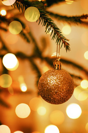 Christmas tree toy on a Christmas tree in warm gold tones, holidayの写真素材