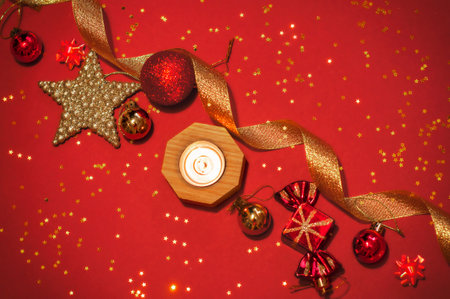 Christmas background with red and gold decorations on red paper, holiday cardの写真素材