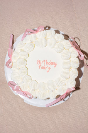 vintage cake with pink bows of delicate cream color, top view