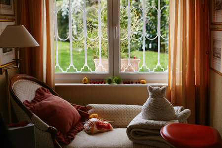 Peach and beige cozy room with teddy cat white vintage sofa and lamp, cute interiorの写真素材