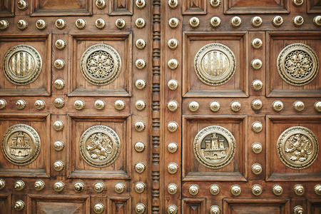 Antique massive doors of carved wood decorated with coats of arms and patterns. Vintage doors of Frankfurt, Germanyの写真素材