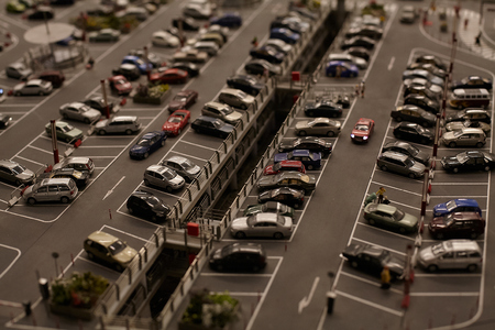 Miniature models figure cars and trucks at the big city parking.の写真素材