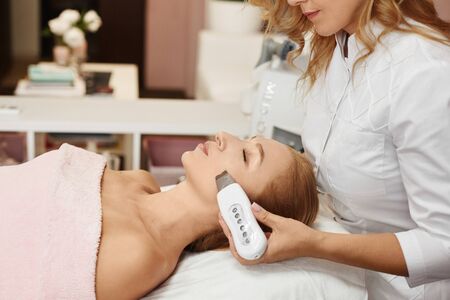 Beautiful woman getting face peeling procedure in a beauty clinic, non-surgical facelifting procedure. Rejuvenating facial treatmentの写真素材