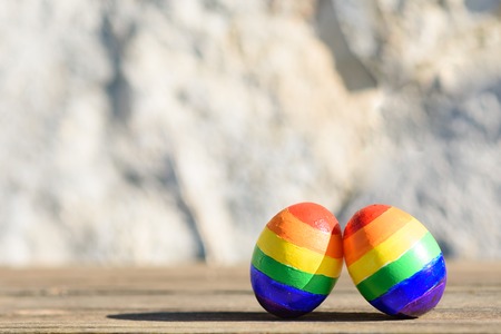 Lgbt couple family. Two eggs with rainbow lgbt flag color on nature outdoor background. Creative...