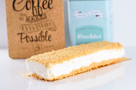 Fluffy, creamy New York Style Cheesecake topped with Crumb on white wood table.Cheesecake is super...
