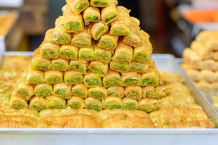 Arabic sweets for celebrate holidays ramadan, iftar,eid on the tray in the market.Selective focus.の写真素材