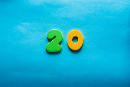 20 years old celebrating classic . Colored happy anniversary 20 th template yellow green numbers. Greetings celebrates card. Traditional framed digits of ages. Sale, special prize, % off concept.の写真素材