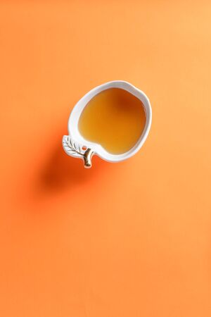 Fresh honey in a glass white apple shape bowl. Top view,copy space, vivid background.Minimal style.の写真素材