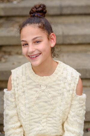 Portrait of a happy smiling teenage girl with dental braces.