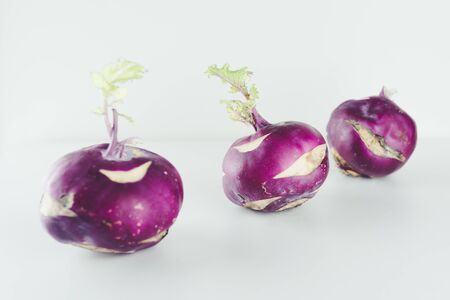 Fresh kohlrabi on white background. Group of raw organic purple turnip cabbage ready to eat.