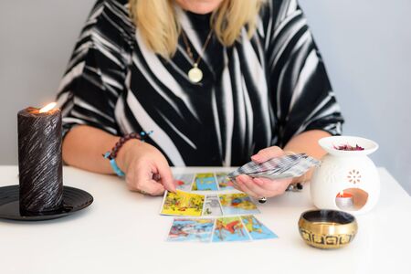 Close up woman hands with tarot cards. Card reading. Divination and clairvoyance.
