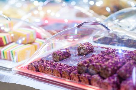 Traditional Turkish Delight Rahat Lokum and Other Oriental Sweets in Market. Traditional Purple Turkish Delight Rose Leaves Lokum Candy.の写真素材