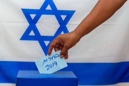 Election in Israel - voting at the ballot box. The hand of man putting vote in the ballot box....