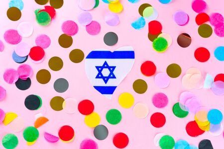 Flag Israel Magen David Star heart shape and holidays colorful confetti on pink background.Welcome Israel, Israeli love.の写真素材