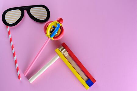 Purim Jewish celebration holiday greeting card. Cute glasses paper mask, colorful wooden noisemakers...