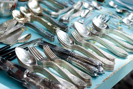 Fork, spoons and knives from nickel silver on the table in Tel Aviv on the flea market.の写真素材