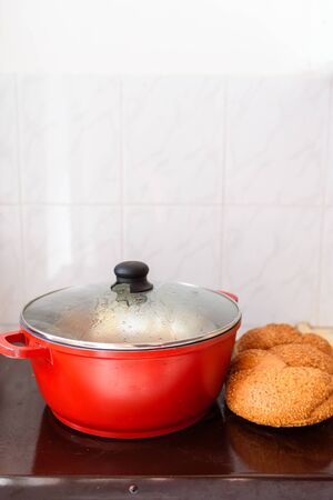 Hot plate for the Sabbath. Pot with traditional food and challah-special bread in Jewish cuisine. Traditional food Jewish Shabbat.の写真素材