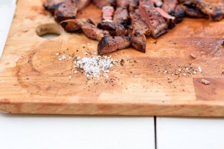 Goose breast with spiced and coarse salt for Christmas on wooden board.の写真素材