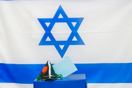Elections Israel. Bacterial respiratory face mask in a box for ballot in election on Israel flag...