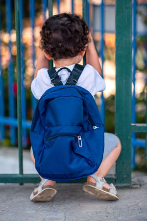 Back to School In the Time of Covid. Rear View Little Curly Schoolboy Ready For School.