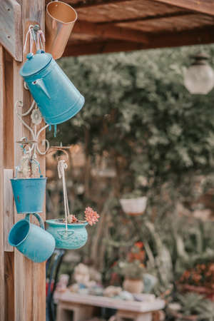 Reduce, reuse, recycle planter craft ideas. Second-hand kettles, saucepans, small bucket and old jug turn into garden flower pots. Recycled garden design and low-waste lifestyle. Vintage style.の写真素材