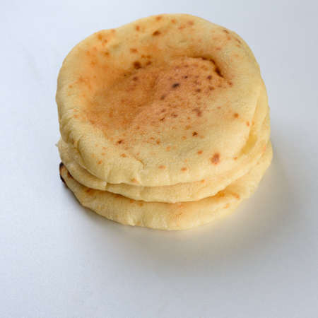 Pita bread on wooden board.Pita used in Arabic and Jewish cuisine for splitting and filling with choice of ingredients.の写真素材