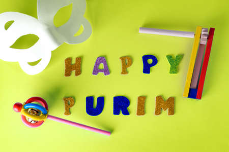 Happy Purim Jewish celebration holiday greeting card. White carnival mask, colorful wooden...