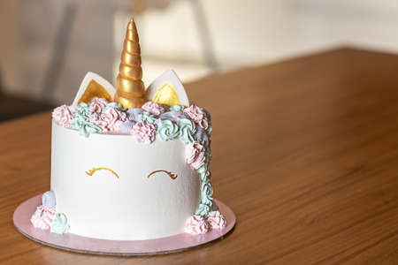 Unicorn cake with multicolor buttercream icing and copy space.