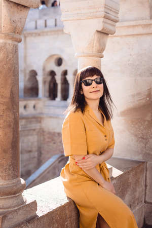 Traveler Woman Portrait. Middle age woman sitting at Fisherman Bastion sunrise in Budapest Hungary.