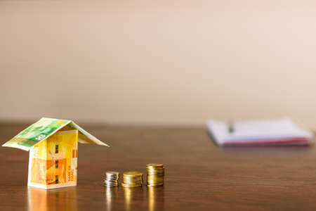 House made out of Israel money creative image. Tent encampments and protest camps spring up across Israel to protest soaring housing high costs and rental prices.の写真素材
