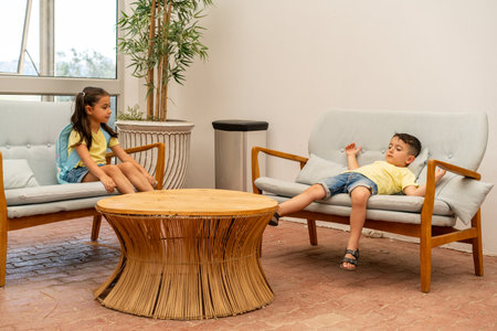 Relaxed Intermission. Two Schoolchildren Unwind and Talk on a Natural Sofa During a Lesson Break.の写真素材