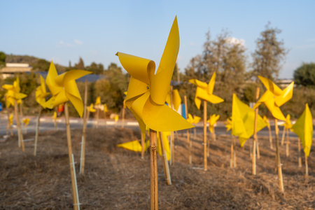 A field filled with yellow pinwheels serves as a poignant tribute to Israeli hostages. This public...